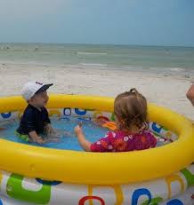 each morning we set up the kiddie pool for the toddlers shaded it with a big beach umbrella and surrounded them with our bea beach fun beach baby beach trip