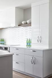 The stainless steel kitchen cabinets are sturdy and look shiny and smart. A Glossy White Hood Positioned Between Wood Shelves Is Flanked By Glossy Flat Front Whit Contemporary Kitchen Cabinets White Modern Kitchen Kitchen Room Design