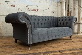 Contemporary living room with a stylish white chesterfield sofa and two grey armchairs. Geneva Chesterfield Sofa House Graphite Grey Velvet Oswald Pablo
