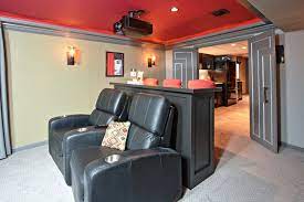 Shop home theater seating from nebraska furniture mart. Remodeled Basement With Theatre Seating Custom Built Bar Counter And Bold Colors Home Theater Seating Basement Remodeling Custom Entry Doors