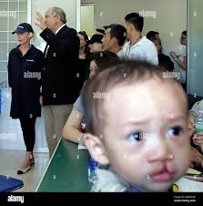 Cindy McCain, wife of Republican presidential candidate Sen. John McCain,  R-Ariz., far left, listens to Operation Smile Chief Medical Officer Randy  Sherman, second from left, as doctors are screening children, who have