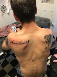 It's possible you've never noticed it, but on the left side of her neck, ariana grande has a small crescent moon tattoo. Pop Crave On Twitter This Fan Got Ariana Grande S Name Tattooed Across His Back