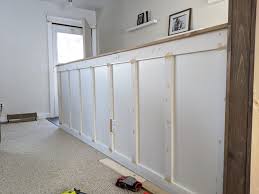 Molding provides a subtle horizontal effect, visually widening the walls of this basement space. Diy Board And Batten What To Do With An Entryway Half Wall