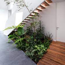 An Indoor Garden Makes Use Of The Space Under These Stairs Small Garden Under Stairs Indoor Garden Stair Decor