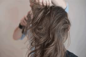 When you reach the middle, combine the 2 sections and tie into a low ponytail. Gif Tutorial How To Create A Ribbon Bun