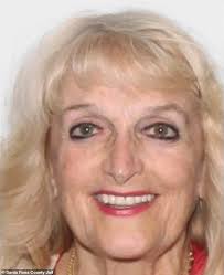 Glamorous Florida doctor, 72, grins in her mugshot as her opioid 'pill  mill' is exposed