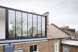The owners of this bathroom have made use of the chunky stone wall beneath the window by topping it with wood, turning it into both a bench and a space for accessories. 13 Weird And Wonderful Loft Conversion Ideas To Inspire You