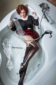 Please be sure to answer the question. Fully Clothed Girl In Leather Skirt Bodysuit Pantyhose And Boots Get Wet In Milk Bath Wetfoto Com
