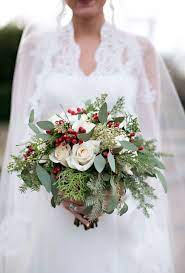 The wedding ceremony and reception will likely be filled with real flowers, so why not add a few floral patterns to wedding decor, or have your bridesmaids wear a pretty floral print? 51 Christmas Wedding Bouquets Ideas Wedding Bouquets Wedding Christmas Wedding Bouquets