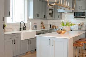 The calacatta marble countertops match with the small white and grey mosaic tile used for the backsplash as well as the slight green tinge used for the kitchen walls. Are Grey Kitchen Cabinets Better Than White Warline Painting Ltd