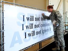 Person writing on a board the following sentences: "I will not tolerate it, I will not condone it, I will not ignore it"