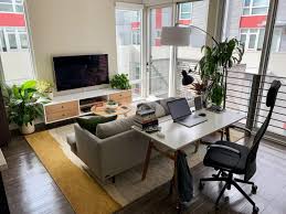 Grouping items into threes is a great way to make a living room feel a bit bigger by adding more pieces to a space without taking up more real estate. Living Room In My First Solo Apartment Imgur Living Room Office Combo Small Apartment Living Room Living Room Setup
