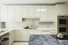 It can even adhere to previously gloss painted surfaces. High Gloss Painted Cabinets At Perimeter And Metalized White Bronze Island Cabinets Sport A Reveal Detail Finger Pull Gloss Cabinets Painting Cabinets Design