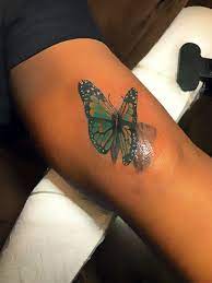 Butterfly Colour Tattoo On Dark Skin Purple Tattoos Purple Tattoo Ink Red Ink Tattoos