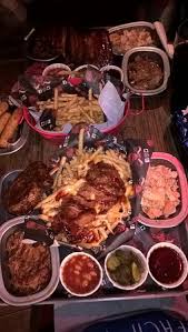 Top 5 Meat Platter Pastrami Pulled Pork Ribs Shredded Chicken Beef Brisket Regular Fries Bottom 3 Meat Platter Pulled Pork Cumberland Sausage Shredded Chicken Pulled Pork Cheese Loaded Fries Picture