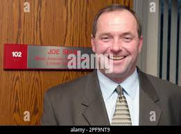Joe Selig, University of Nebraska's interim athletic director, is  photographed Tuesday Dec. 17, 2002 in front of a plaque bearing his name,  in Lincoln, Neb. Selig has been a part of the Cornhuskers' athletic  department since he was a freshman at the school ...