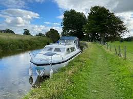 One tan and the other is green. Norman 23 Cabin Cruiser Canal Boat Cheap Boats