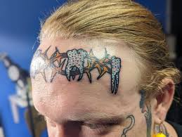 Image result for quirky pylon forehead tattoo