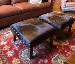 This ottoman table would work in a casual cabin or an elegant mountain mansion. Cowhide Ottoman Coffee Table Made To Any Size You Need