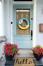 Add color to your door or porch with this red geranium welcome door wreath. Summer Wreath Ideas Fun Front Door Decor