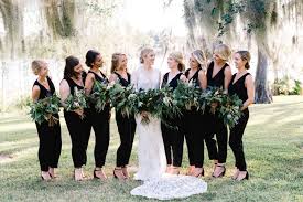 Bride In Her Gown Of All Lace And Heirloom Veil Bridesmaids In Chic Black Jumpsuits All Hold A Wedding Jumpsuit Bridesmaid Black Bridesmaid Dresses Bridesmaid