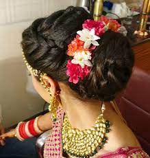 What A Beautiful Large Low Bun With Real Flower Gajra Care However Should Be Taken Before Adopting Bridal Hair Updo Hair Styles Braided Hairstyles For Wedding