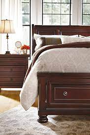 About porter the warm rustic beauty of the porter bedroom collection uses a deep finish and ornate details to create an inviting furniture collection that fits comfortably into any bedroom décor. Porter Queen Sleigh Bed With Mirrored Dresser And Chest Ashley Furniture Homestore