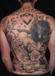 The cross mark in the pray hand tattoo depicts to the lord jesus. Black Ink Heart With Praying Hands And Roses Tattoo On Man Full Back