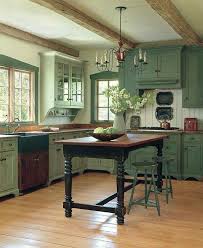 Sage Green Kitchen Cabinets With Antique Stretcher Based Table As The Kitchen Island Country Kitchen Designs Rustic Kitchen Cabinets Home Kitchens