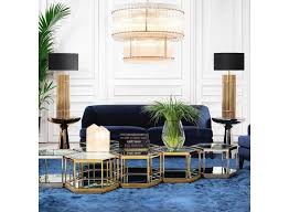 A gold and black lamp with glass accents, this light fixture brings bold style to a side table in a bedroom, living room, or hallway. Table Lamp Reef Wilhelmina Designs