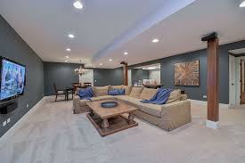 This expansive finished basement features lightly colored carpeting and recessed lighting throughout. Drew Nicole S Basement Remodel Pictures Basement Living Rooms Basement Remodeling Basement Remodel Diy