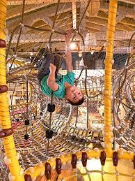 Boy Climbing Inside Rope Play Net Suspended From Ceiling At Karl S Potato Chip Adventure World Playground Design Natural Playground Playground