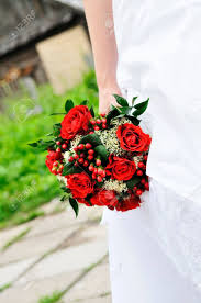 The leaves are alive with colors and the air is crisp. Bride Holding Beautiful Red Wedding Flowers Bouquet Stock Photo Picture And Royalty Free Image Image 10255567