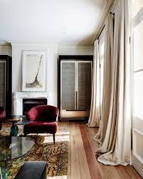 Long Flowing Drapes Curtains In Modern Living Room With Hardwood Flooring And Red Chair Curtains Living Room Interior Home