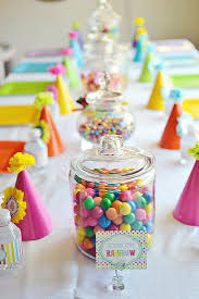 Birthday Party Table Decorations For Kids Rainbow Birthday Table The Table Is Set A Simple White Fabric Covered The Lunch Table Adorned With B Rainbow Birthday Party Rainbow Parties Rainbow Birthday