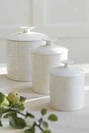 These vintage hand painted faux books provide storage space for spices and set of 3 kitchen canisters for storing flour, white sugar and brown sugar. White Ceramic Storage Jars Ceramic Kitchen Canisters Jar Storage Kitchen Storage Canisters