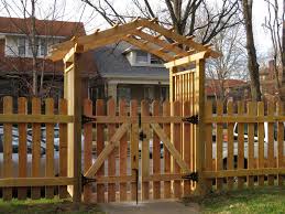 White picket fences are traditional in style, but can also incorporate more modern elements, such as arbors or curved top edges. Project Spotlight Picket Fence With An Arbor Gate The Fence Guy Of Louisville