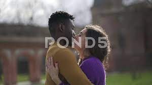 Interracial couple kissing and hugging e... | Stock Video | Pond5