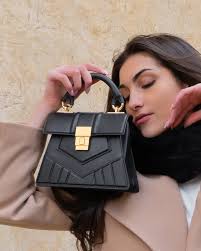 An Early Spring Sojourn in Florence, Spring/Summer 2025 Campaign shooting,  Dadaputia. Futuristic Kelly bag in black. On Location: Piazza San Lorenzo,  Florence, Italy.