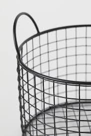 Line a wire basket with a graphic dish towel, perhaps one printed with garden themes, and include potted amaryllis or freesia parents of babies will appreciate being gifted board books and rattles, as well as extra clothes, bibs and blankets. Round Metal Wire Basket Black Home All H M Us Black Wire Basket Wire Baskets Metal Wire