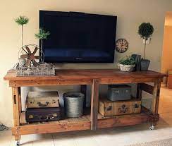 Rustic Industrial Workbench Turned Entertainment Center I Love The Antique Suitcases Too Furniture Pallet Furniture Home Decor