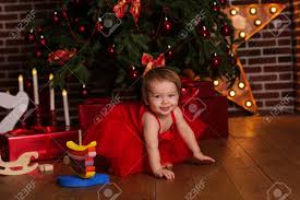 Keeping up the ongoing trends we have curated this list for your baby girl. Cute Pretty Baby Girl Is Wearing Red Dress Near Beautiful Xmas Tree Stock Photo Picture And Royalty Free Image Image 65728772
