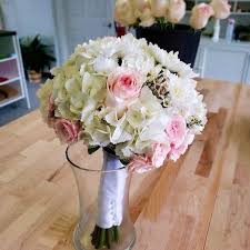 Typically, this flower is inexpensively priced. Wedding Bouquet White Hydrangea And Pink Roses By Southern Coast Flowers
