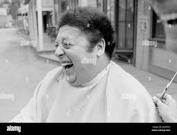 Comedian Marty Allen, fuzzy-haired member of the comedy team of Allen &  Rossi, has a laugh after seeing the result after having his hair styled by  barber Sol Goldstein in Hollywood, Calif.,