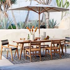 Outdoor Dining Gets An Upgrade With Its Richly Grained Wood Angled Legs And Slanted Mid Century Dining Table Modern Outdoor Dining Modern Outdoor Dining Area