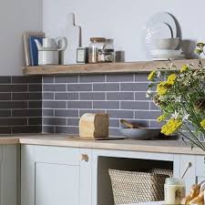 Black and white moroccan style cement tiles create a dynamic contrast to gray quartz countertops in an upgraded kitchen. Diy Guide Tiling A Kitchen Splashback Tiles Direct