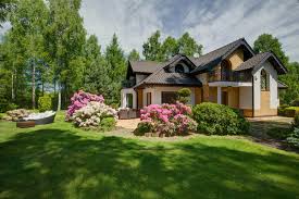 An image of a modern house with slated roof and a garden laid to lawn and overlooking the sea. An Independent House With Beautiful Garden Stock Photo 03 Free Download