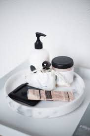 I love how the caning on the front mimics the design of the tile wall: Round Marble Tray Marble Tray Beautiful Bathroom Vanity Bathroom Styling