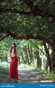 Photo of Fashion Woman with Naked Breast in Red Dress in Fairy Forest.  Stock Photo - Image of model, asian: 87097710