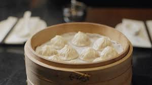 The real din tai fung xiao long bao is most likely made with pork skin and/or chicken feet (the collagen helps the stock to gelatinize) but using gelatin is a cheaper and easier method. Din Tai Fung